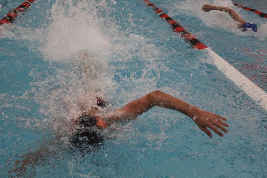 A Libertyville swimmer pulls ahead of an opponent in a freestyle race.