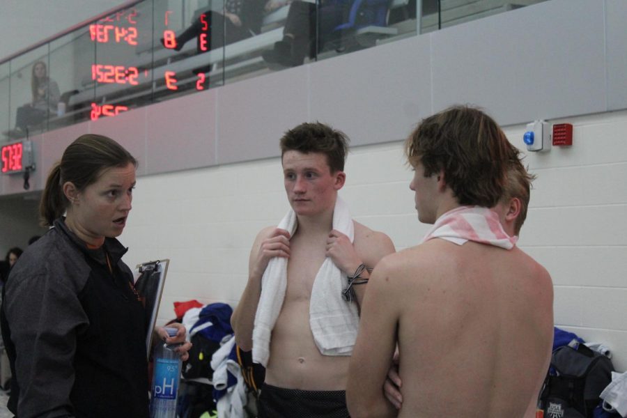 Coach Amanda Perchauer has a quick discussion with the team captains prior to the start of the meet.