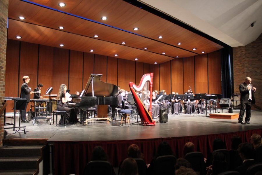 Mr. Gohr explained to the audience the musical piece In a Nutshell, performed by the Wind Ensemble. This composition included music written in both 1916 and 2011.