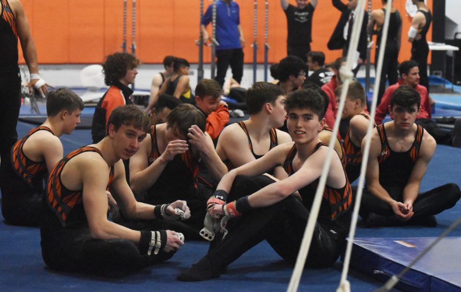 The boys gymnastics team supported their fellow teammates who were competing on high bar.
