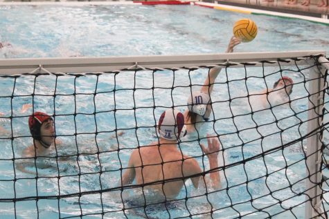 A Maine East defender blocks a Libertyville shot attempt.