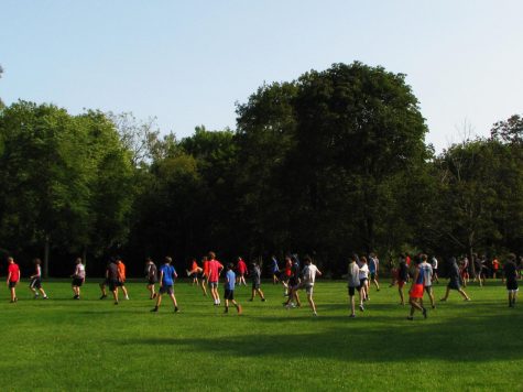 The boys cross country team warms up together at Adler Park while maintaining COVID-19 guidelines by social distancing and wearing masks.