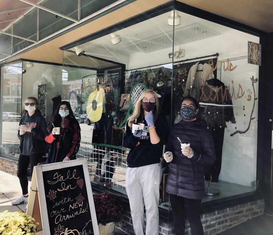 The girls tennis team painted the Forest Bootery windows.