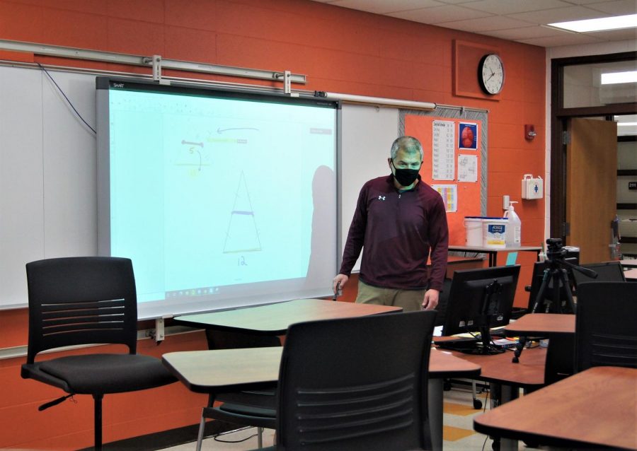 Math teacher Tim Budge teacher from his empty classroom in the LHS building while his students learn from home.