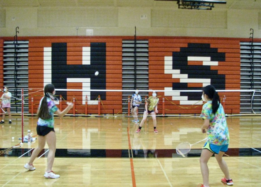 Varsity badminton players start their season with doubles games and COVID-19 precautions.