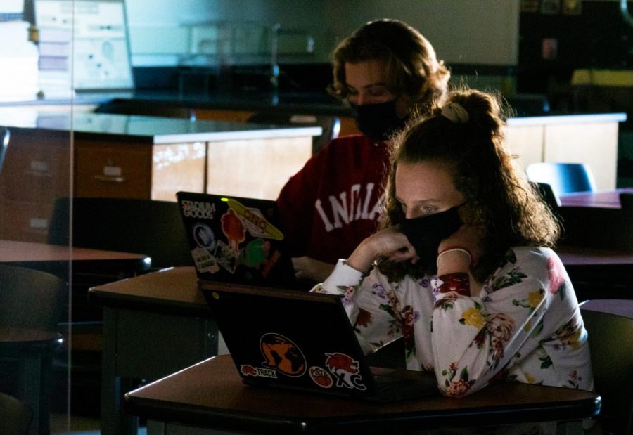 In most classrooms, student desks are placed six feet apart, some with protective shielding in between.