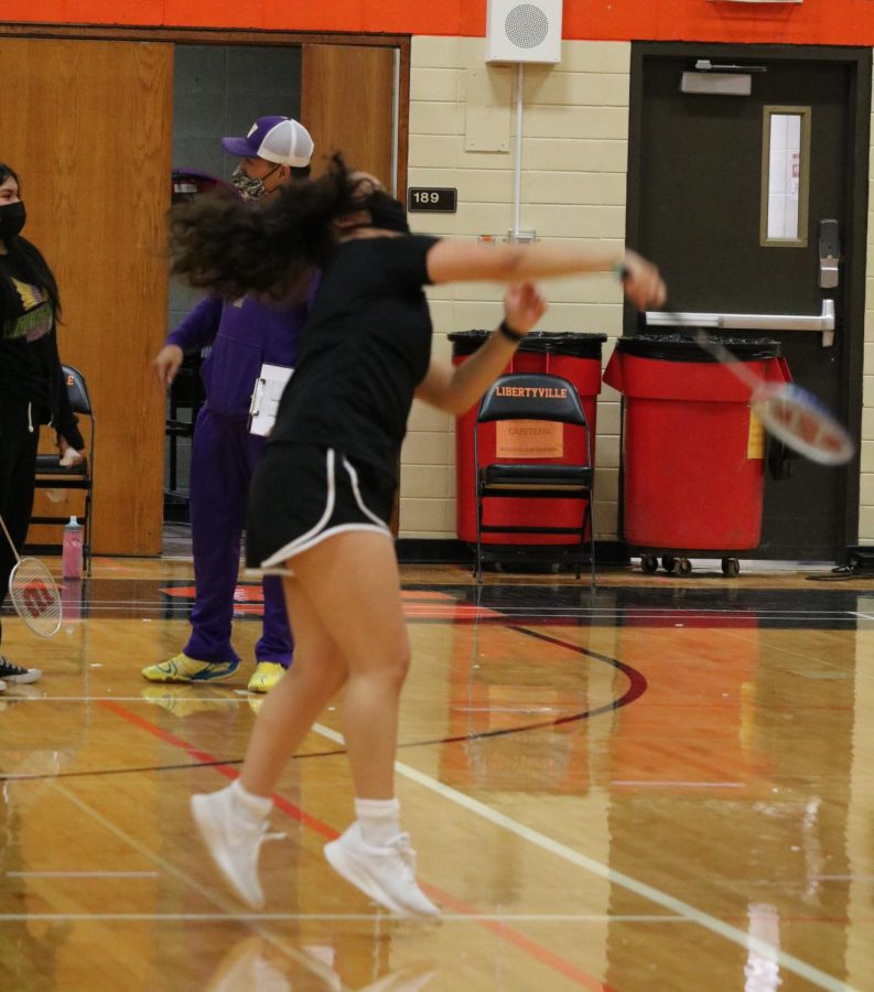 Ashley Cervantes leaves her feet for a smash shot in her singles match.