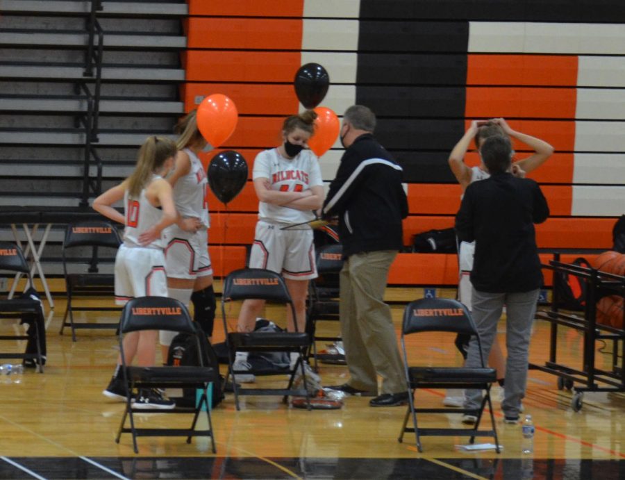 Before the game, players meet with Coach Greg Pedersen to talk about their game plan.