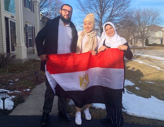 Rofaida Abdel Rahman, pictured in the middle, moved from Egypt, then to Canada, and finally to the U.S.. She and her parents are shown holding the flag of Egypt.