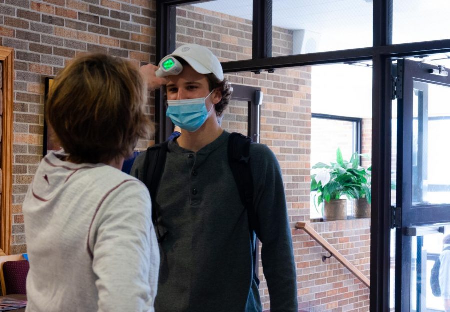 Upon entering the building, students are required to have their temperature checked. The auditorium entrance features one of the temperature check stations.