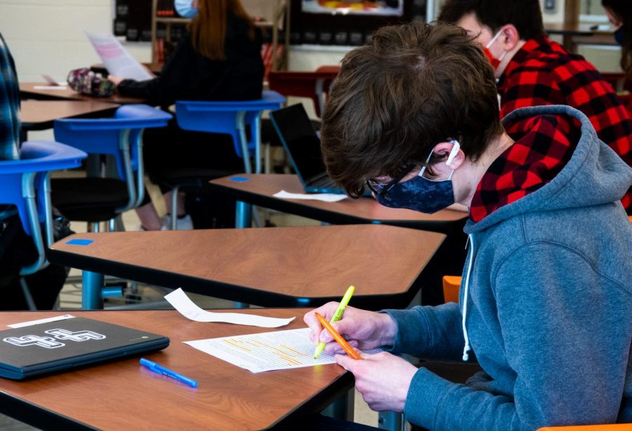 In-person AP Literature students utilize class time and resources, such as printed copies of passages, to engage with the material.