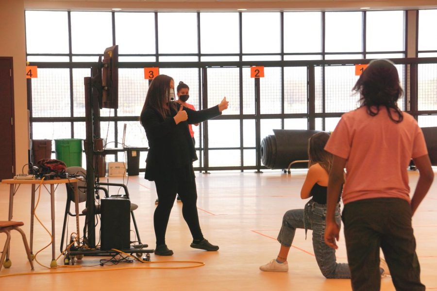 Dance teacher Eryn Brown not only gives directions and critiques to the performers but also makes sure that the rehearsal is following proper safety precautions. A monitor is set up during rehearsal to allow remote performers to watch.