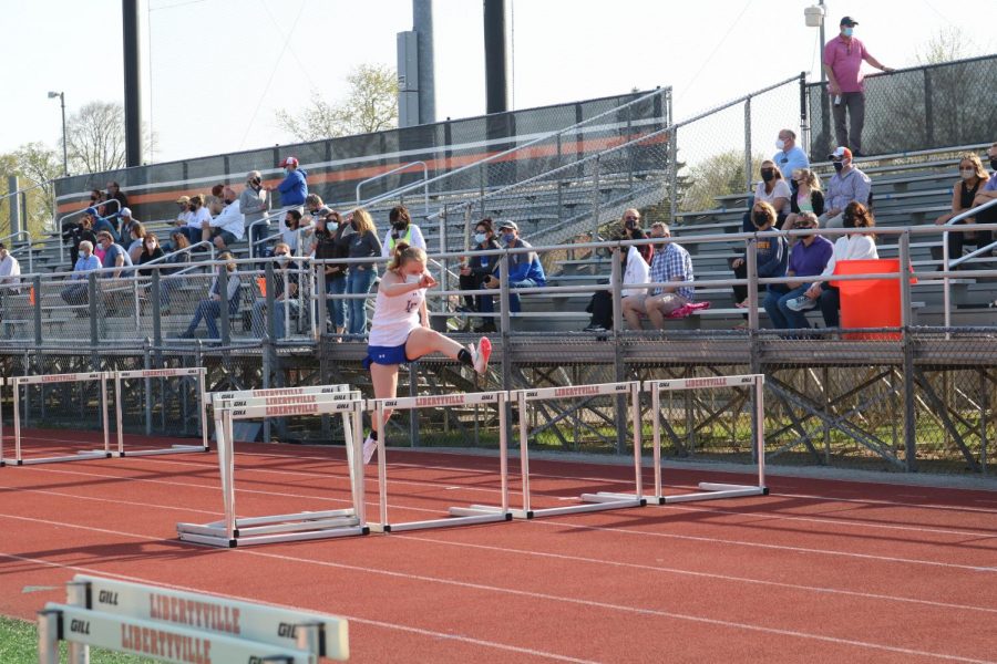 A Lake Forest track member practices her hurdles before her race.