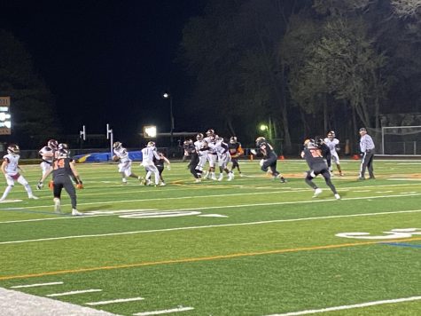 Connor Dickson (14), John Stokovich (24), and the Wildcat defense pursue the Zion ball carrier.