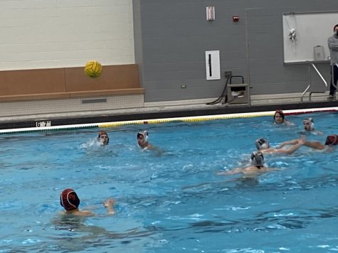 Sam Otto passes the ball back to an open Yaseen Tolba in the middle of the pool.