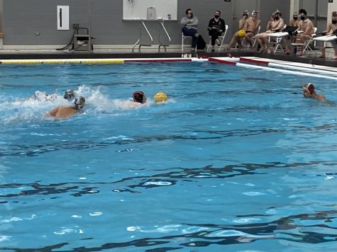 Preston Knapp swims with the ball on a fast break. 
