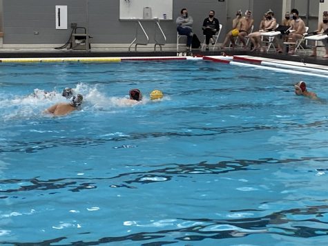 Preston Knapp swims with the ball on a fast break.