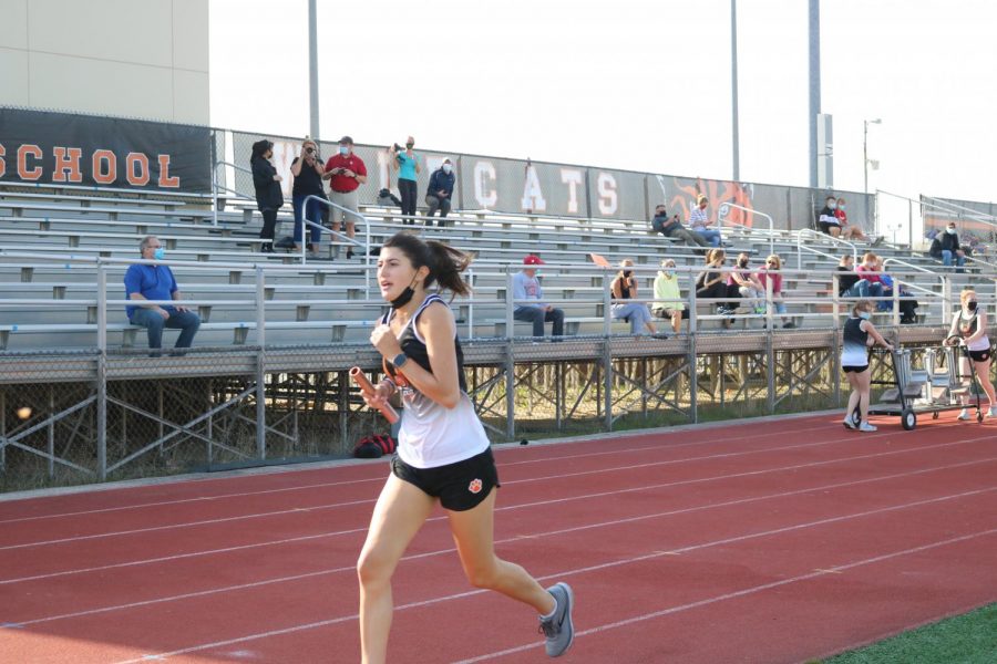 Senior Mia Vernasco finishes the last leg of the 4 x 800 meter relay, bringing the team into 1st place in that event.