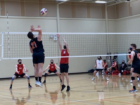 Reece Wiatrowksi (21) jumps for a left-side spike