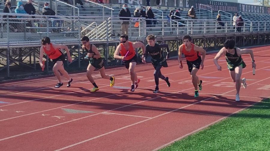 LHS runners (from left to right, in orange) Danny Woja, Gabe Banek and Andrew Brooks are spaced out among Stevenson runners to start the first leg of the 4x800 relay.