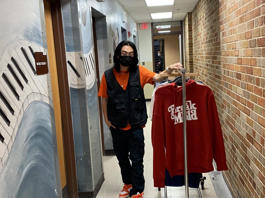 Mark walking through the hallway with his favorite selection of clothing.