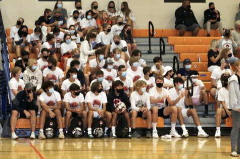 Students meet at the West Gym to support the volleyball team in their match against Waukegan High School. Girls volleyball and boys soccer have been the main focus so far for the renewed student section.