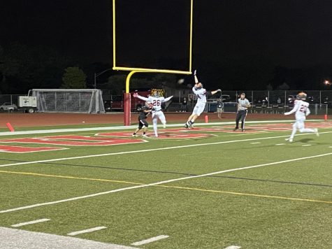 Dylan Holmes (26) and Connor Wolff (24) combine for an endzone pass-breakup. 