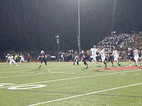 Connor Dickson (1) leaps to complete a pass to Brett Scheuneman (11) as rain falls in the late 4th quarter. 