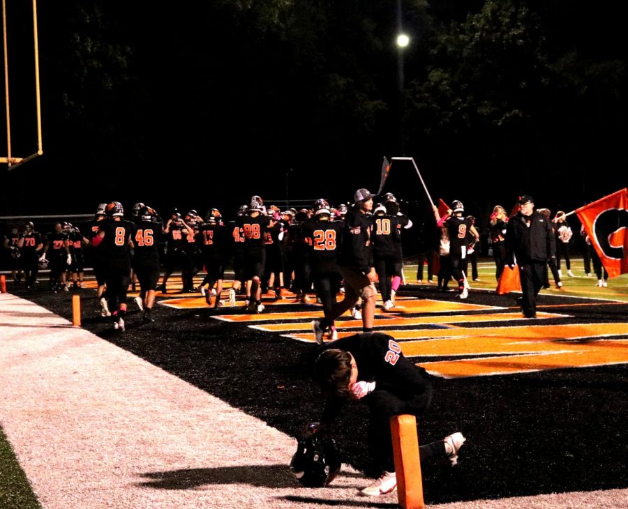 Senior John Stokovich (20) pauses for a moment before the game.