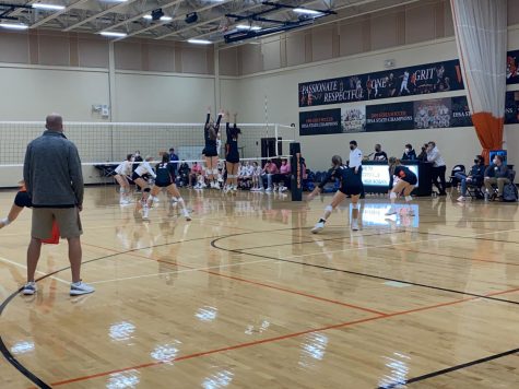 Middles Margot Ashley Branford (left) and Margot Kaufman (right) leap to defend the Cats.