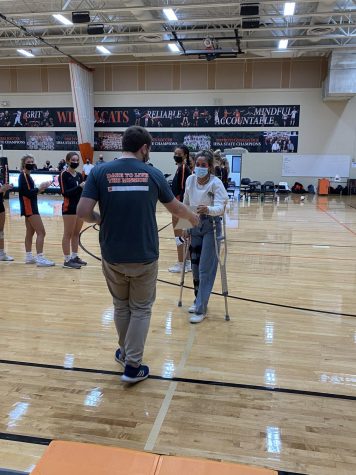 Mr. Murchison, one of eleven teachers recognized at the game, receives his Teacher Appreciation award from Amelia Doughty.