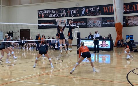 Kelly Hutchins (26) and Margot Kauffman (13) jump for the block while Keira Kasten (22), Grace Comilla (5) and Grace Bonjour (18) prepare for a deflection.