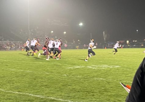 Andrew Scott (2) breaks loose down the sideline on a kick return with blocks from Trent Adams (8), Casey Wells (35), and Theo Schmidt (79).