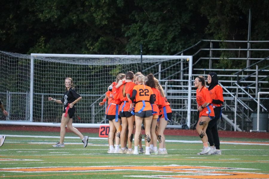 Team Orange huddles together, sharing tactics and strategy