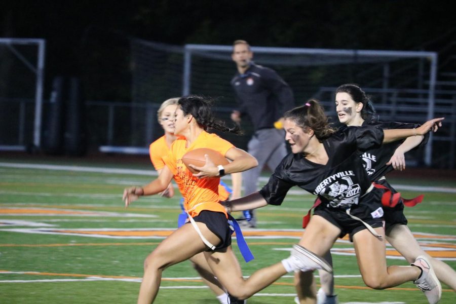 Kayla Talerico lunges for the flag of her opponent, Arielle Mendoza.