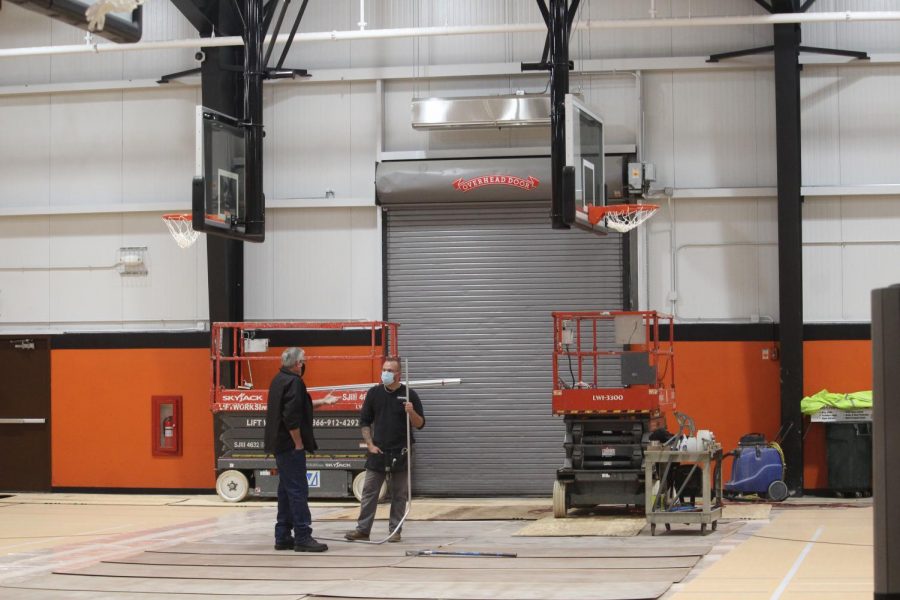 The project continues as anchors are installed for the badminton and volleyball nets within the newly renovated floors.