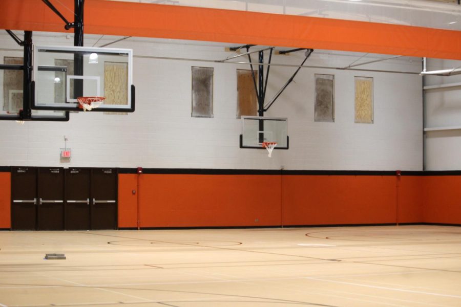  The vibrant orange walls and the warm wood-colored floor gives the new space more life than the previous grey color scheme.