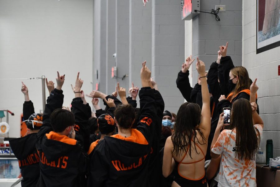 The Wildcats join together for their team cheer, led by the seniors.