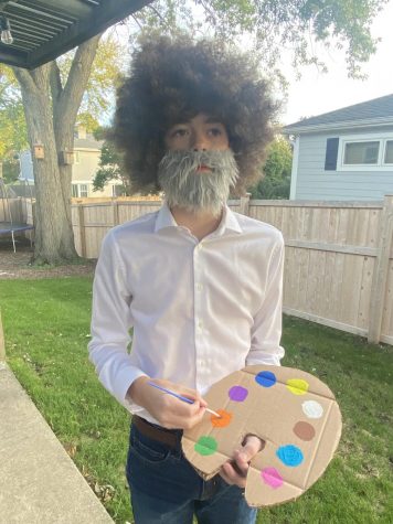 This timeless costume showcases the generational love for the famous painter, Bob Ross. From the iconic hair-do to the art palette in his hands it's an excellent execution of the ever so famous painter. If only there was a painting to complete this iconic look, but don't worry, I'm sure it was just a happy accident.