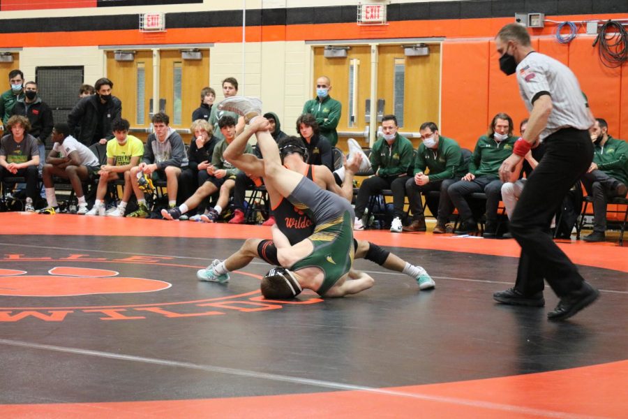 Senior wrestler Caelan Riley fights off his Stevenson opponent, and later pins him, giving six points to LHS during the varsity dual meet on December 3.