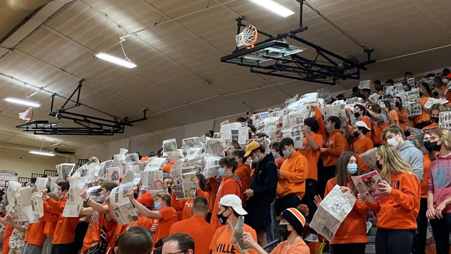 The Student Section goes all out in orange while showing their disinterest in Lake Forest’s player introductions by reading newspapers, a trend seen at many universities around the country.