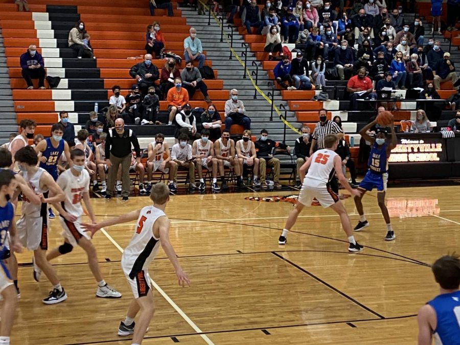 Chase Bonder (25) guards a Scouts player at the three point line as Will Buchert (5) begins the line of defense in the paint.