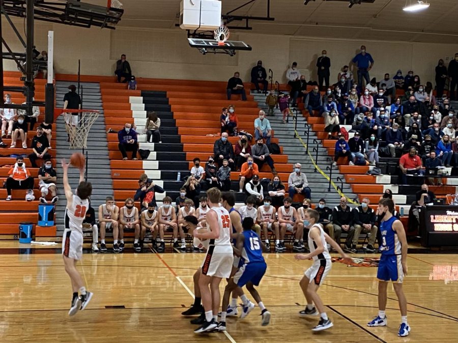 John Graham (20) lunges for a rebound on a missed free throw attempt by the Scouts as Aidyn Boone (40), Chase Bonder (25), and Will Buchert (5) box out their opponents.