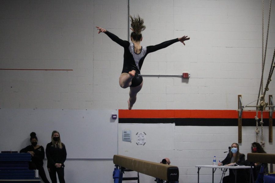 Senior Emaline Frey exhibits an incredible leap, which would eventually score her a 7.60, making her the winner of the balance beam event. 