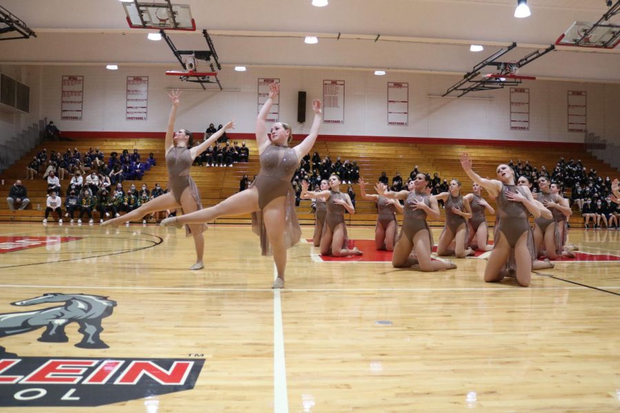 Seniors Ryan McGrory (left) and Sarah Wolter (right) move in synch as the other dancers reach towards them.