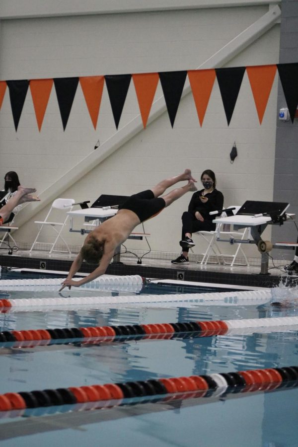 Freshman Sebastian Baldowski leaps off the starting block for pre-game warm ups.