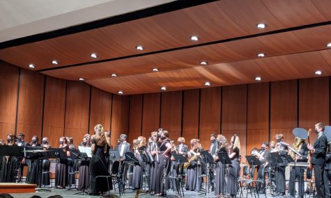 Wind Ensemble stands to take a bow moments before receiving a standing ovation, after blowing away the audience with their last and final piece “Come Sunday” by Omar Thomas. 

