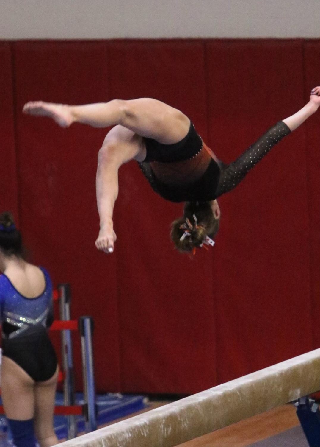 On Feb. 19, Anna Becker executes a flip flop layout step out on the balance beam in the state competition at Palatine High School. While also qualifying to compete for a yurchenko full twist on the vault, she also qualified for bars. Becker qualified for state for gymnastics during her freshman year and finished in the top ten for vault and bars.