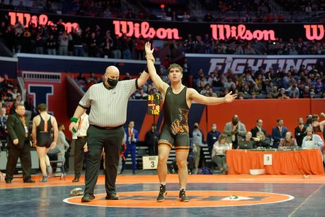 On Feb. 19, the referee holds Josh Knudten up to celebrate his victory after the overtime win in the state finals in Champaign. He won the state finals by a go behind with twenty seconds left. Knudten was satisfied with finishing the season off this way.