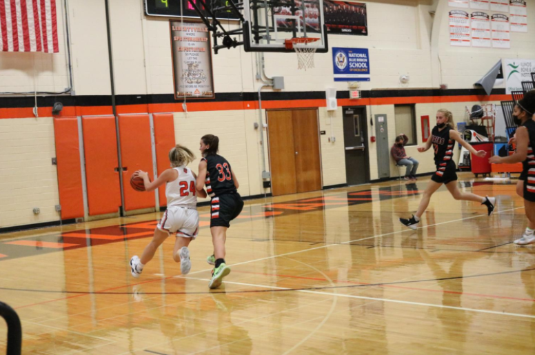 Sophomore Kate Rule drives past her opponent towards the basket. 